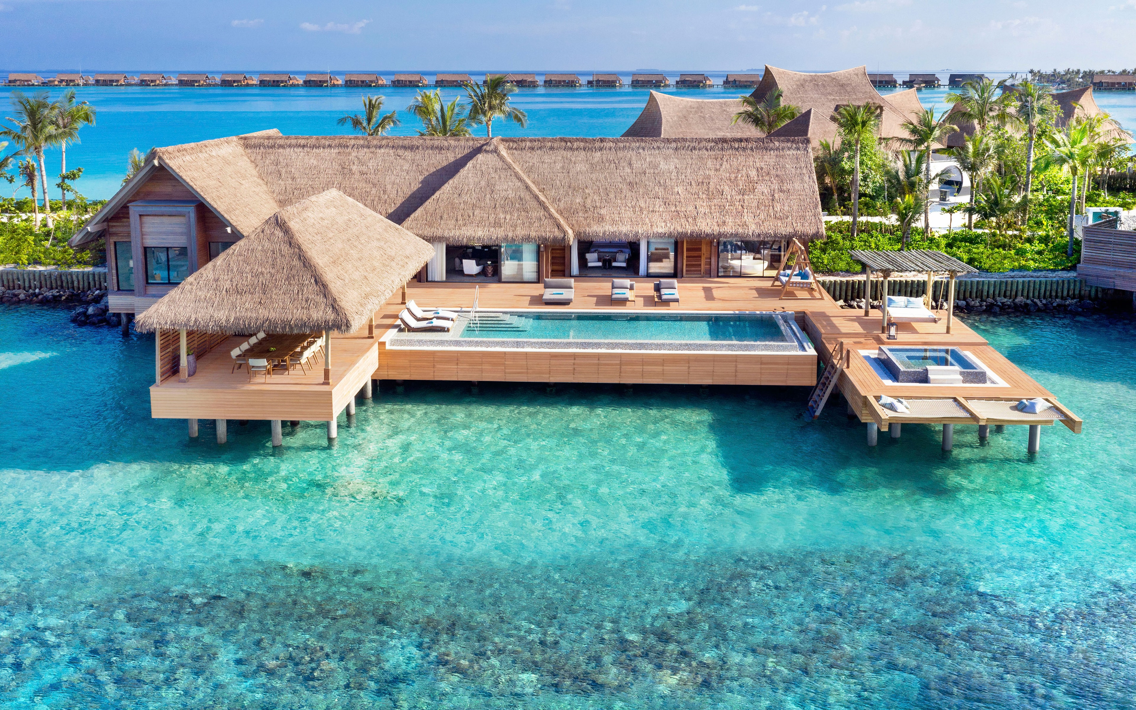 Waldorf Astoria Maldives Ithaafushi overwater villa aerial view turquoise lagoon