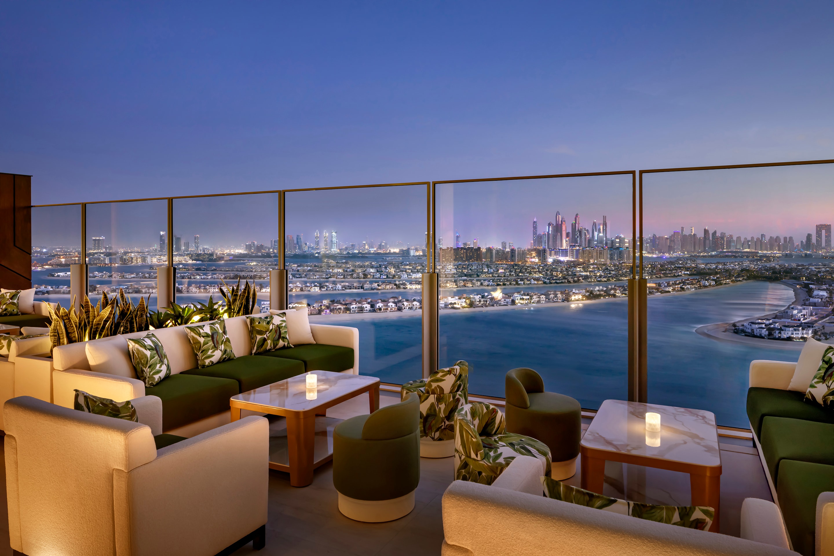 Luxury Dubai Palm lounge with panoramic city views at dusk